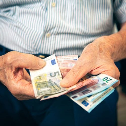 Older mature retired man counting the little money left until the end of the month. Pension concept. Selective focus.