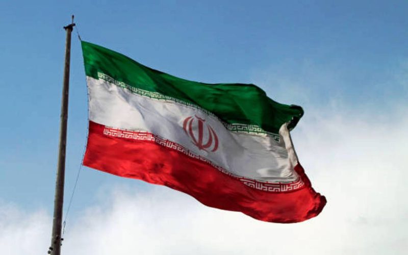 A big flag of Iran waving in the wind in Tehran, Iran.