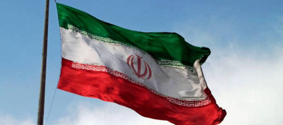 A big flag of Iran waving in the wind in Tehran, Iran.