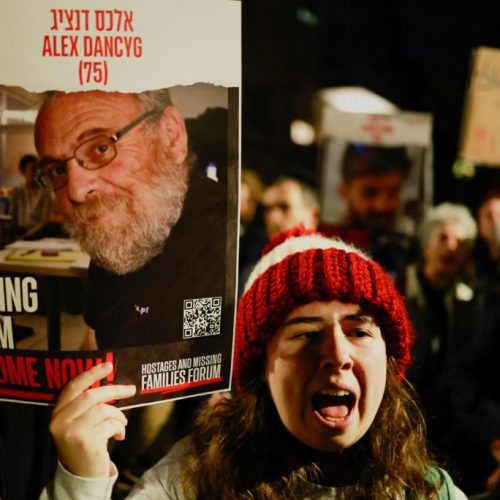Families of hostages and supporters hold signs during a protest to call for the immediate release of hostages kidnapped during the deadly October 7 attack by Palestinian Islamist group Hamas, outside Israeli Prime Minister Benjamin Netanyahu's residence, in Jerusalem January 22, 2024. REUTERS/Ammar Awad