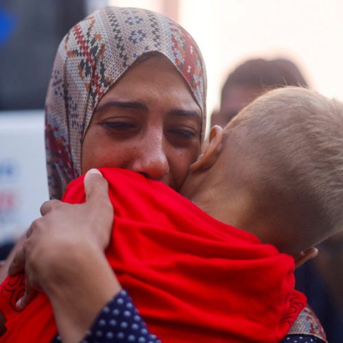 A Palestinian mother hugs her son, who is a patient, before he is transferred for treatment abroad through the Kerem Shalom crossing, amid the Israel-Hamas conflict, in Khan Younis in the southern Gaza Strip June 27, 2024. REUTERS/Mohammed Salem