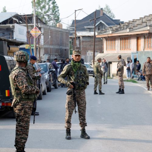 Indian security force personnel stand guard near the site of a fighter jet crash in Wuyan in south Kashmir's Pulwama district May 7, 2025. REUTERS/Sharafat Ali