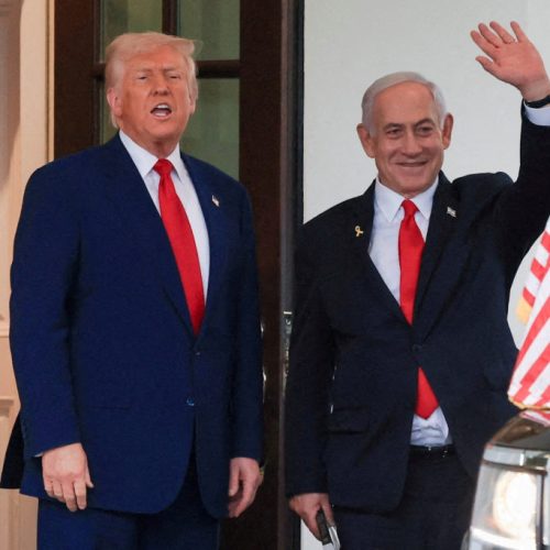 FILE PHOTO: U.S. President Donald Trump speaks as Israeli Prime Minister Benjamin Netanyahu waves following a meeting in the White House, in Washington, U.S., April 7, 2025. REUTERS/Kevin Mohatt//File Photo