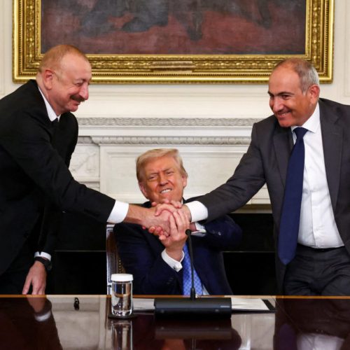 U.S. President Donald Trump holds the hands of Azerbaijan's President Ilham Aliyev and Armenia's Prime Minister Nikol Pashinyan as they shake hands between each other during a trilateral signing event, at the White House, in Washington, D.C., August 8, 2025. REUTERS/Kevin Lamarque     TPX IMAGES OF THE DAY