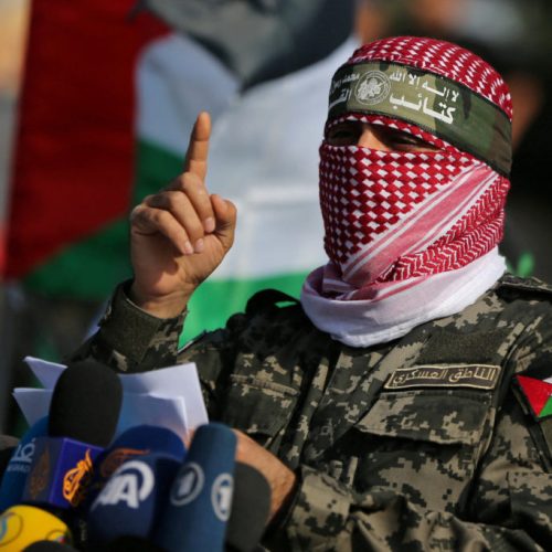FILE PHOTO: Abu Ubaida, the spokesman of the Izz el-Deen al-Qassam Brigades, gestures as he speaks during an anti-Israel military show in the southern Gaza Strip November 11, 2019. REUTERS/Ibraheem Abu Mustafa/File Photo