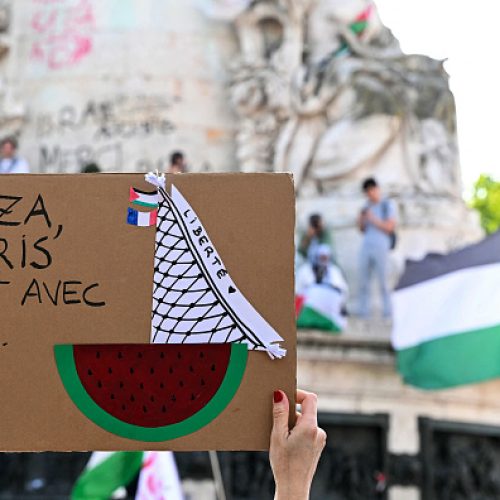 Protestors hold Palestinian flags and a sign reading "Gaza, Paris is with you", during a rally in support of the "Gaza boat" on the Place de la Republique square in Paris on June 10, 2025. On June 10, 2025, Israel deported Swedish Greta Thunberg by plane to Sweden via France, after she was arrested on board an aid boat for Gaza with other pro-Palestinian activists who were taken to Ben Gurion airport for deportation. Of the 12 people on board the sailing boat Madleen, two French nationals agreed to be deported on June 10, while four others declined pending a court decision, French Foreign Minister Jean-Noël Barrot announced. (Photo by Hugo MATHY / AFP) (Photo by HUGO MATHY/AFP via Getty Images)