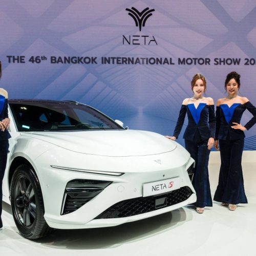 Models stand next to the NETA S from Chinese electric vehicle (EV) manufacturer BYD at the 2025 Bangkok International Motor Show at the Impact Arena convention venue in Bangkok on March 24, 2025. (Photo by Chanakarn Laosarakham / AFP)