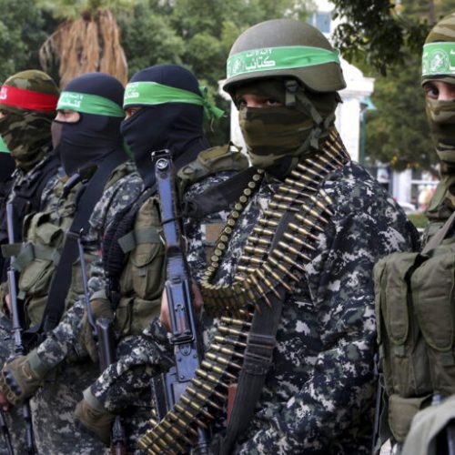 FILE -- In this Dec. 18, 2016 file photo, masked militants from the Izzedine al-Qassam Brigades, a military wing of Hamas, attend the mourning ceremony for Mohammed Alzoari, a Tunisian aviation engineer who was shot dead in Tunisia, at the unknown soldier square in Gaza City. A new political program of Hamas, published Monday, May 1, 2017,  is meant to help the Islamic militant group break out of its international isolation. (AP Photo/Adel Hana, File)