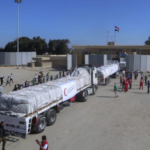 Trucks of Egyptian Red Crecent carrying humanitarian aid for the Gaza Strip cross the Rafah border gate, in Rafah, Egypt, Saturday, Oct. 21, 2023. (AP Photo/Mohammed Asad)