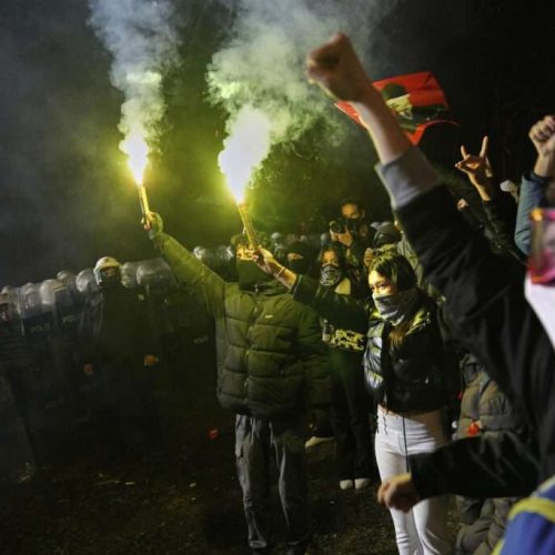 People shout slogans next to anti riot police officers in Istanbul, Turkey, Monday, March 24, 2025, during a protest after Istanbul's Mayor Ekrem Imamoglu was arrested and sent to prison. (AP Photo/Khalil Hamra)