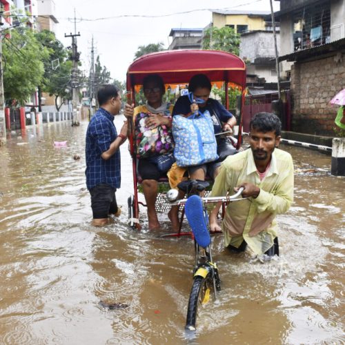 Residents cross a flooded street on a cycle rickshaw after heavy rains in Guwahati, India, Saturday, May 31, 2025. (AP Photo)