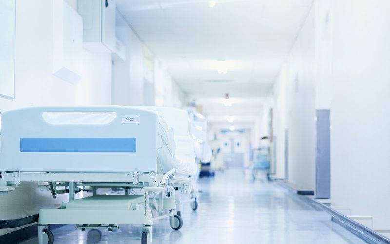 Shot of a hospital bed in an empty corridor of a modern hospital