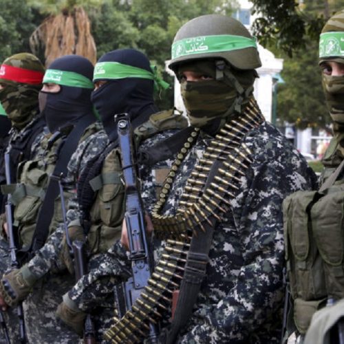 FILE -- In this Dec. 18, 2016 file photo, masked militants from the Izzedine al-Qassam Brigades, a military wing of Hamas, attend the mourning ceremony for Mohammed Alzoari, a Tunisian aviation engineer who was shot dead in Tunisia, at the unknown soldier square in Gaza City. A new political program of Hamas, published Monday, May 1, 2017,  is meant to help the Islamic militant group break out of its international isolation. (AP Photo/Adel Hana, File)