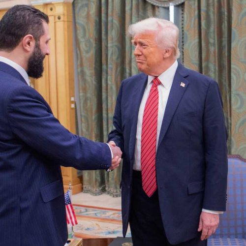 In this photo released by the Saudi Royal Palace, President Donald Trump, right, shakes hands with Syria's interim President Ahmad al-Sharaa, in Riyadh, Saudi Arabia, May 14, 2025. (Bandar Aljaloud/Saudi Royal Palace via AP)