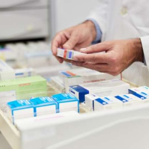 Cloe-up view of a pharmacist hands holding merchandise.