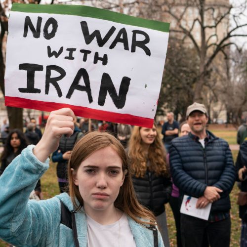 WASHINGTON, DC - JANUARY 04: A demonstrator holds a sign during a protest against war in Iraq and Iran outside the White House on January 4, 2020 in Washington, DC. Demonstrations are taking place in several U.S. cities in response to increased tensions in the Middle East as a result of a U.S. airstrike that killed an Iranian general last week. (Photo by Alex Edelman/Getty Images)