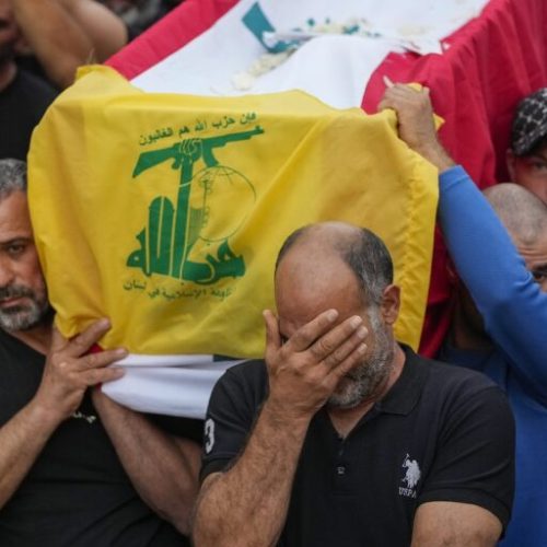 Draped with a Hezbollah and Lebanese flag, mourners carry the coffin of their relative, killed on Saturday in an Israeli airstrike, during a funeral procession in Maisara near the northern coastal town of Byblos, Lebanon, Monday, Oct. 14, 2024. (AP Photo/Hassan Ammar)