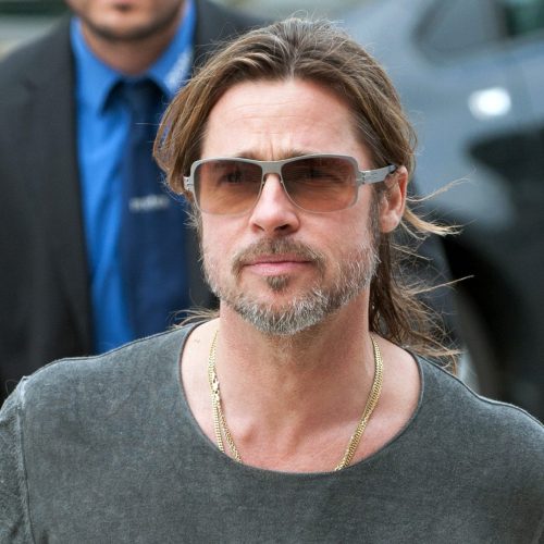 epa03264800 US actor Brad Pitt walks towards the New Gallery at Documenta (13) accompagnied by security personnel in Kassel, Germany, 14 June 2012. The exhibition of contemporary and modern art runs until 16 September 2012.  EPA/UWE ZUCCHI