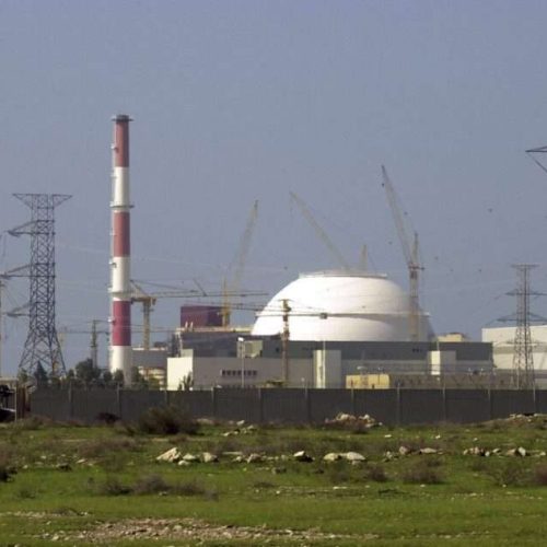 The reactor building of Iran's nuclear power plant and electricity poles are seen, at Bushehr, Iran, 750 miles (1,245 kilometers) south of the capital Tehran, Iran, Feb. 27, 2005. (AP Photo/Vahid Salemi, File)