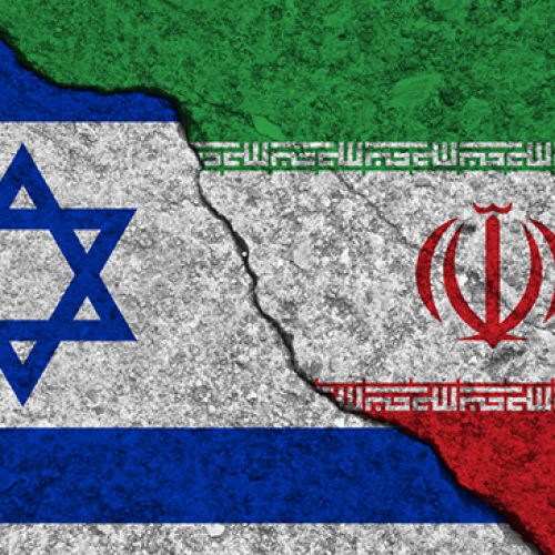 Cracked painted concrete walls between the Israel flag and Iran. Concept of conflict or bad relationship.