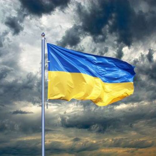 Ukraine flag. Ukrainian flag on black storm cloud sky. stormy weather