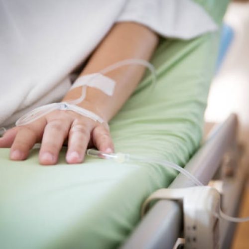 Focus patient's hand has get the saline solution syringe on it. Illness and treatment. Health insurance plan. Reimbursement and Medical expenses. image for illustration, copy space, article.