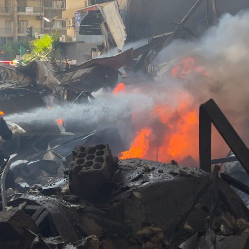 Firefighters extinguish burned cars at the site of an Israeli airstrike in central Beirut, Lebanon, Wednesday, April 8, 2026. (AP Photo/Hussein Malla)