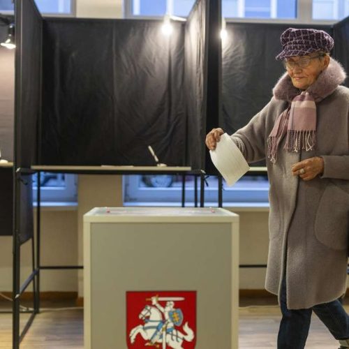 A local resident walks to cast their ballots at a polling station during a second round of voting in parliamentary election, in Vilnius, Lithuania, Sunday, Oct. 27, 2024. (AP Photo/Mindaugas Kulbis)