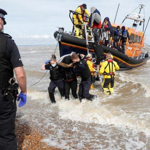 FILE PHOTO: A RNLI boat, with migrants onboard, is met by Border Force Officers and Police at the harbour in Dungeness, Britain, September 13, 2021. REUTERS/Peter Nicholls/File Photo