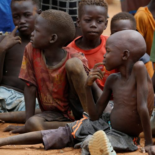 Orphans and children separated from their parents in Kadugli gather to eat boiled leaves for food at an IDP Camp within Sudan People's Liberation Movement-North (SPLM-N) controlled area in Boram County, Nuba Mountains, South Kordofan, Sudan June 22, 2024. REUTERS/Thomas Mukoya/File Photo
