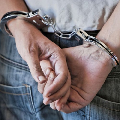 Young man in handcuffs
