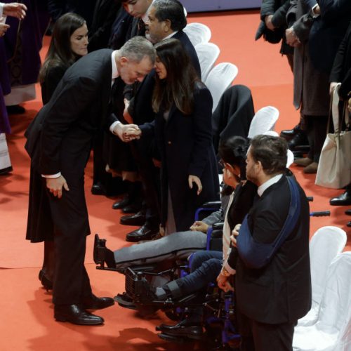 Spain's King Felipe talks to a woman next to injured victims during a funeral mass in memory of the victims of the deadly derailment of two high-speed trains in Adamuz, at the Carolina Marin Sports Palace in Huelva, Spain, January 29, 2026. REUTERS/Jon Nazca
