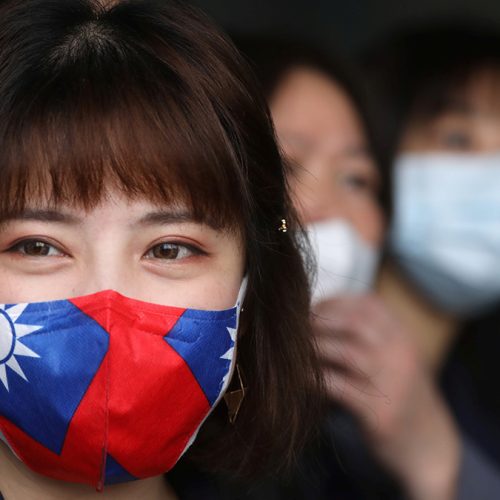 A staff wears a face mask with a Taiwanese flag design, as protection due to the coronavirus disease (COVID-19) outbreak, at a factory for non woven filter fabric used to make surgical face masks, in Taoyuan, Taiwan, March 30, 2020. REUTERS/Ann Wang - RC24UF97P3H2