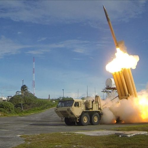 The first of two Terminal High Altitude Area Defense (THAAD) interceptors is launched during a successful intercept test. The test, conducted by Missile Defense Agency (MDA), Ballistic Missile Defense System (BMDS) Operational Test Agency, Joint Functional Component Command for Integrated Missile Defense, and U.S. Pacific Command, in conjunction with U.S. Army soldiers from the Alpha Battery, 2nd Air Defense Artillery Regiment, U.S. Navy sailors aboard the guided missile destroyer USS Decatur (DDG-73), and U.S. Air Force airmen from the 613th Air and Operations Center resulted in the intercept of one medium-range ballistic missile target by THAAD, and one medium-range ballistic missile target by Aegis Ballistic Missile Defense (BMD). The test, designated Flight Test Operational-01 (FTO-01), stressed the ability of the Aegis BMD and THAAD weapon systems to function in a layered defense architecture and defeat a raid of two near-simultaneous ballistic missile targets