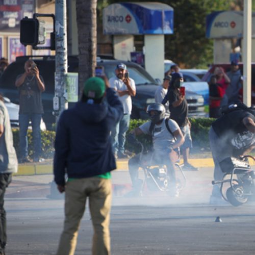 Protesters demonstrate during a standoff between police and protesters following multiple detentions by Immigration and Customs Enforcement (ICE), in the Los Angeles County city of Paramount, California, U.S., June 7, 2025.   REUTERS/Daniel Cole