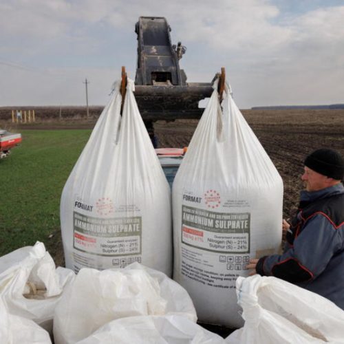 FILE PHOTO: A local farm worker unloads Ukrainian-made fertiliser from a truck to use on a wheat field near the village of Yakovlivka after it was hit by an aerial bombardment outside Kharkiv, as Russia's attack on Ukraine continues, April 5, 2022. REUTERS/Thomas Peter/File Photo